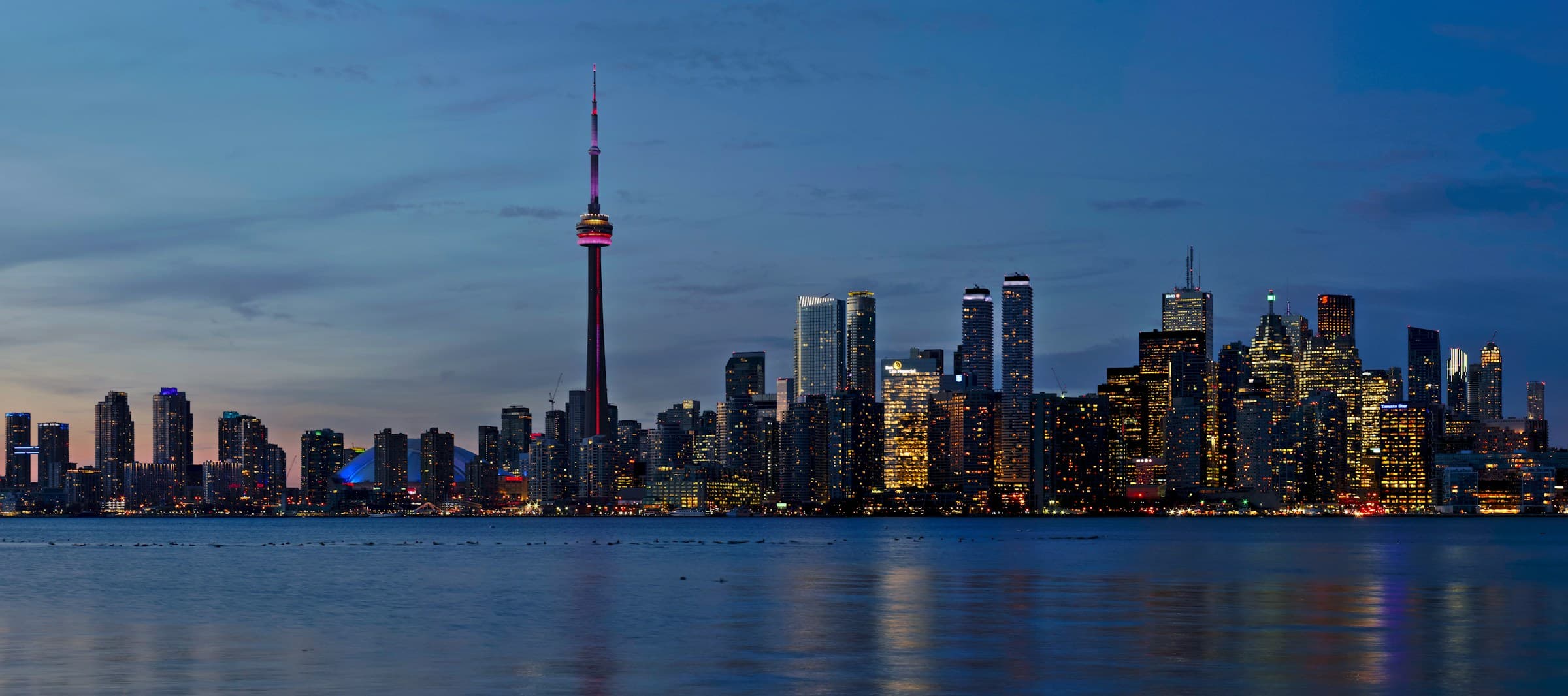The Toronto skyline at dusk, seen across the water from the Toronto Islands